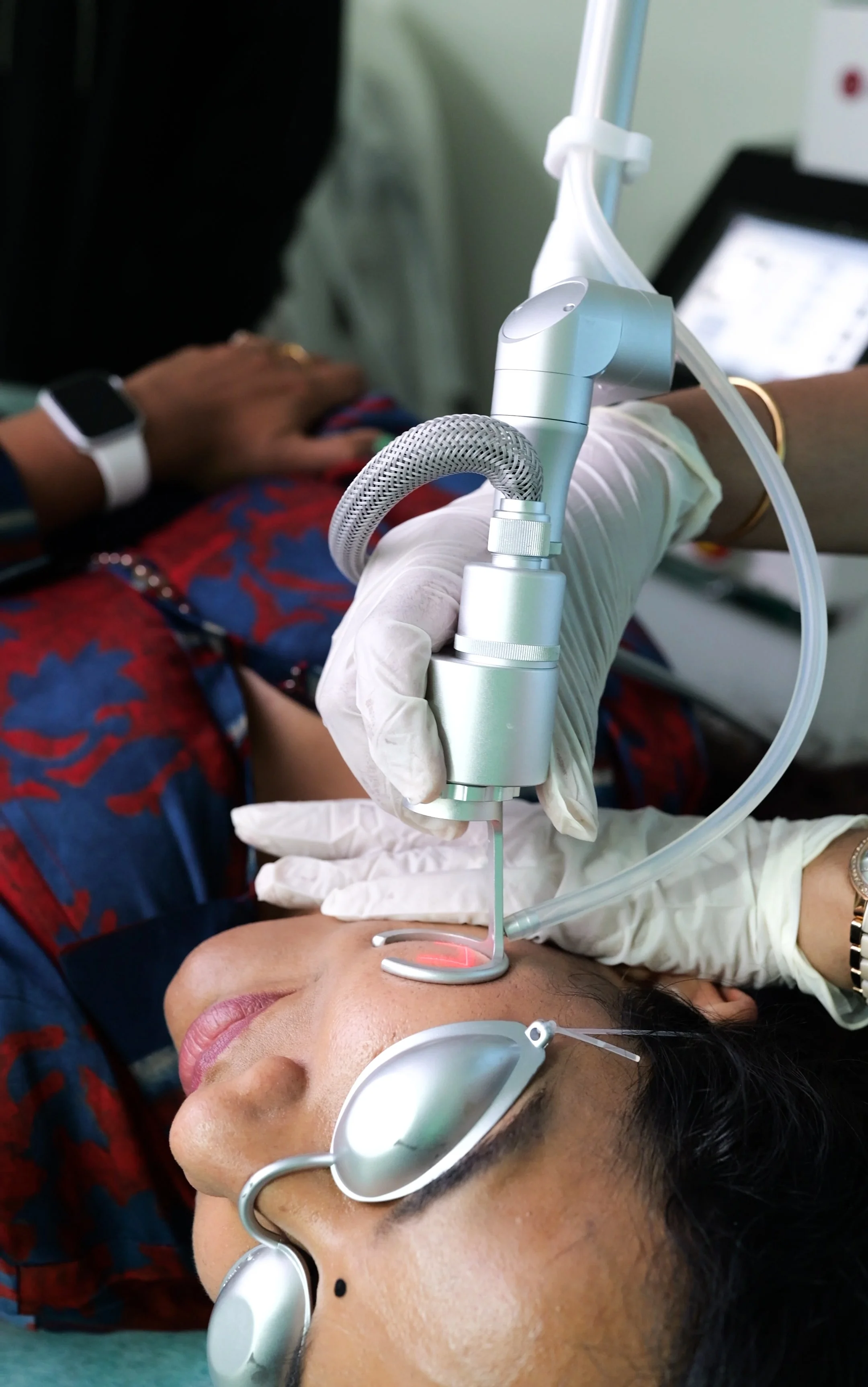 Dermatologist at DermaVue Coimbatore clinic examining a patient with acne scars during a consultation
