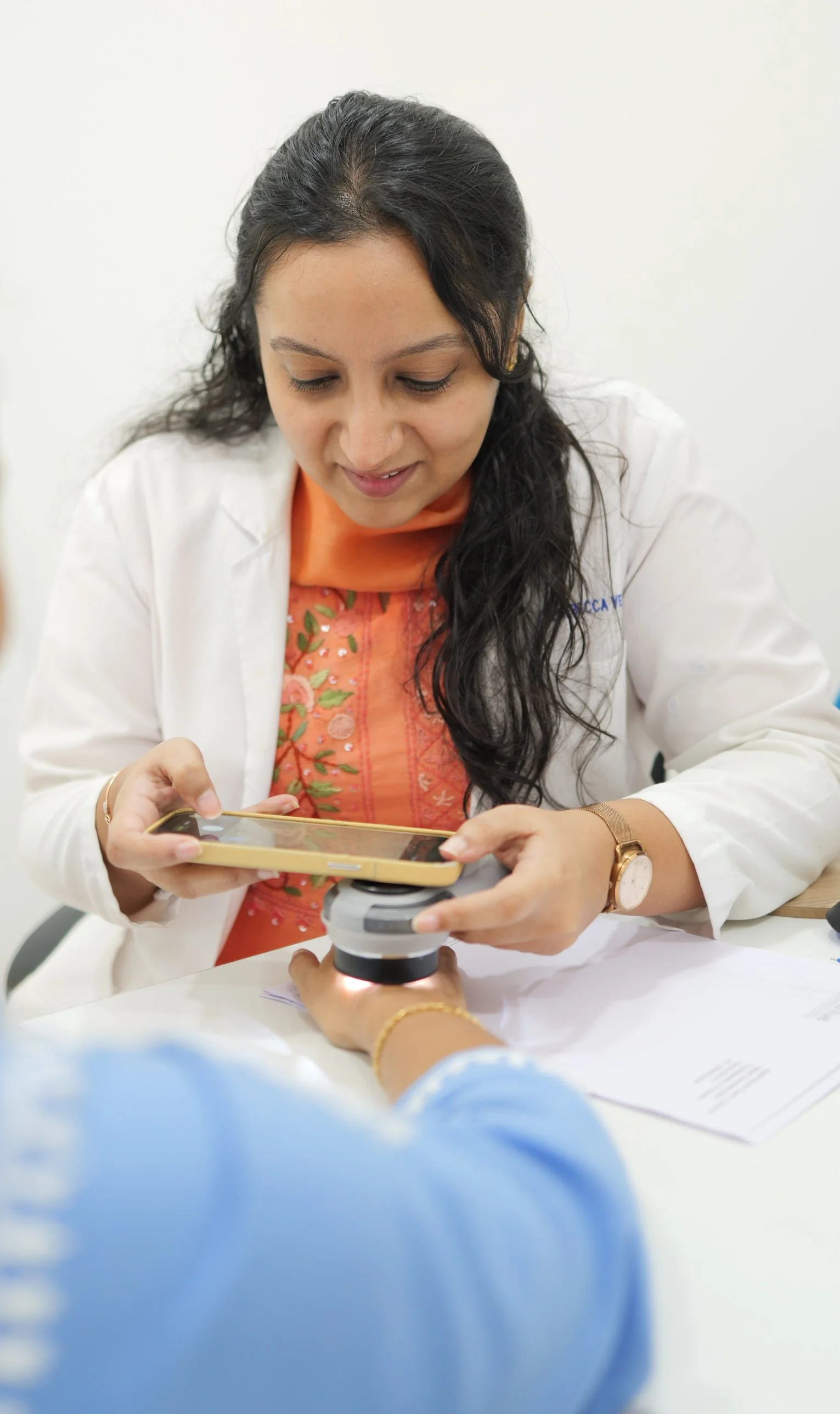 Dermatologist at DermaVue clinic examining a patient with a skin rash during a consultation