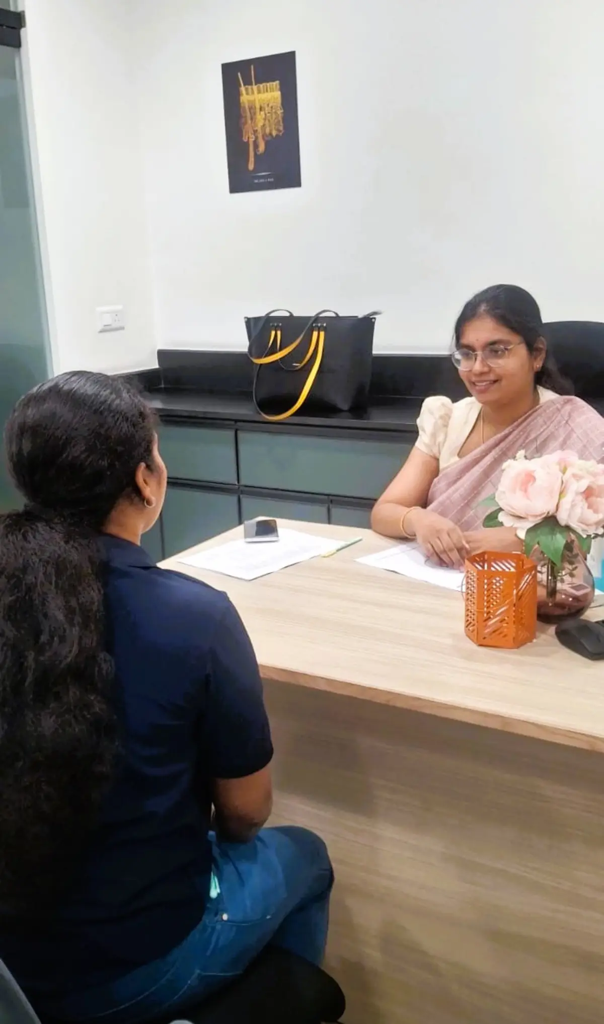 Dermatologist at DermaVue Coimbatore examining a patient's scalp for hair fall causes