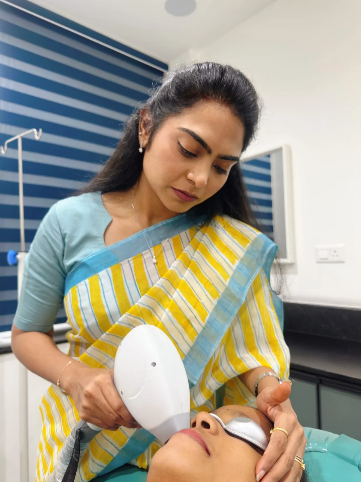 Dermatologist performing laser hair removal treatment at DermaVue Kochi clinic in Aluva