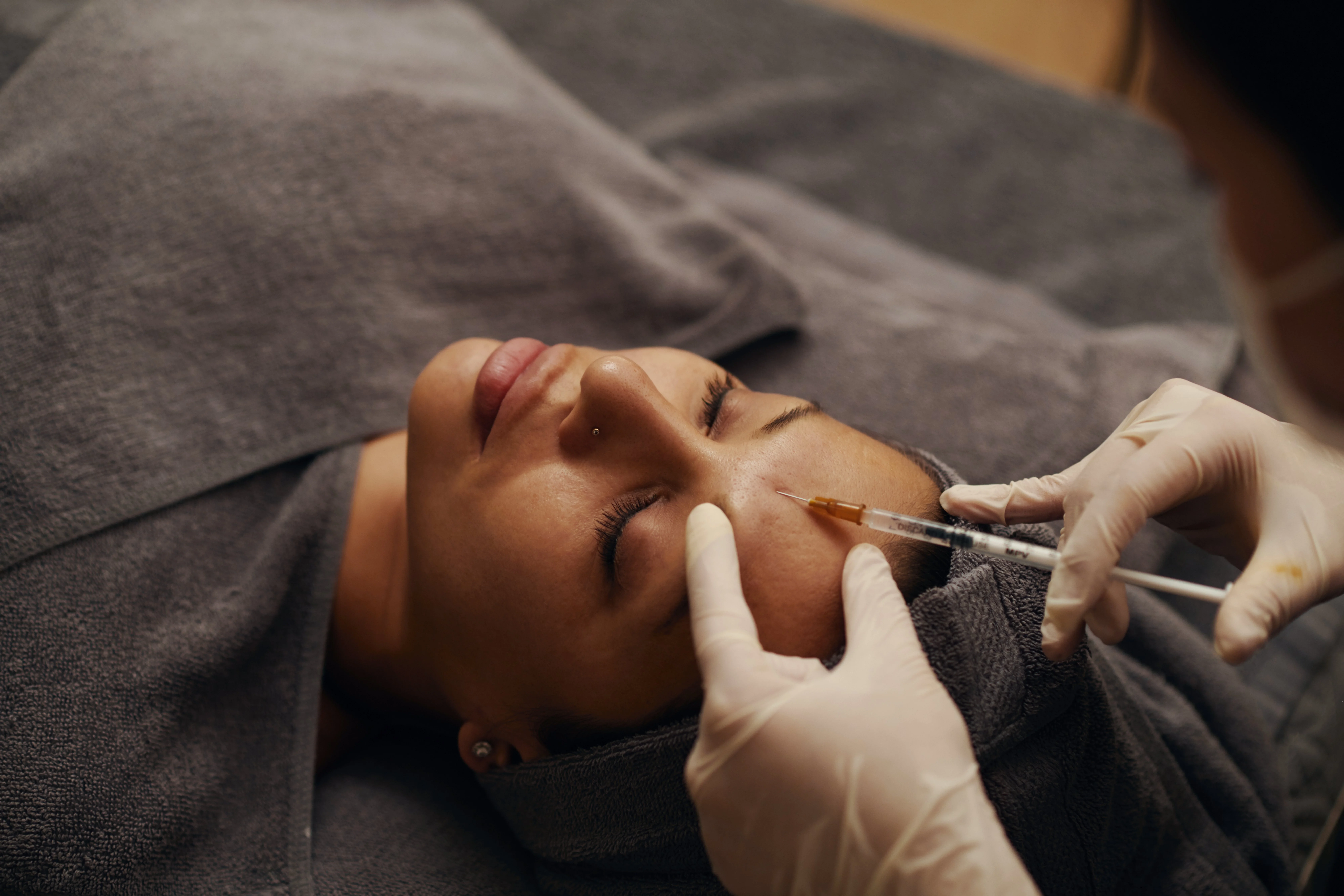 Dermatologist at DermaVue clinic consulting a young patient about preventive Botox treatment